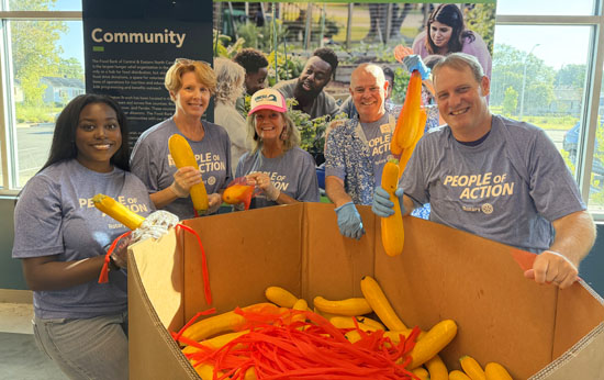 Rotarian volunteers sort and pack more than 6,000 pounds of fresh produce at Food Bank..
